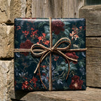 Moody dark floral wrapping paper with burgundy flowers and twine on a gift box by Wrapped Studios.