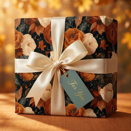 Luxury autumn floral wrapping paper with a cream satin bow on a gift box by Wrapped Studios.