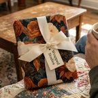 Luxury floral wrapping paper with rust orange autumn flowers and cream ribbon bow by Wrapped Studios.