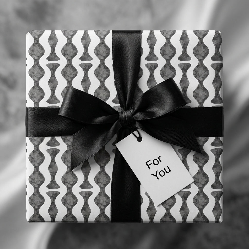 Luxury black and white modern wrapping paper with a black ribbon bow and gift tag by Wrapped Studios.