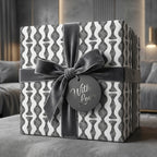 Modern grey and white geometric wrapping paper with a luxury velvet bow by Wrapped Studios.