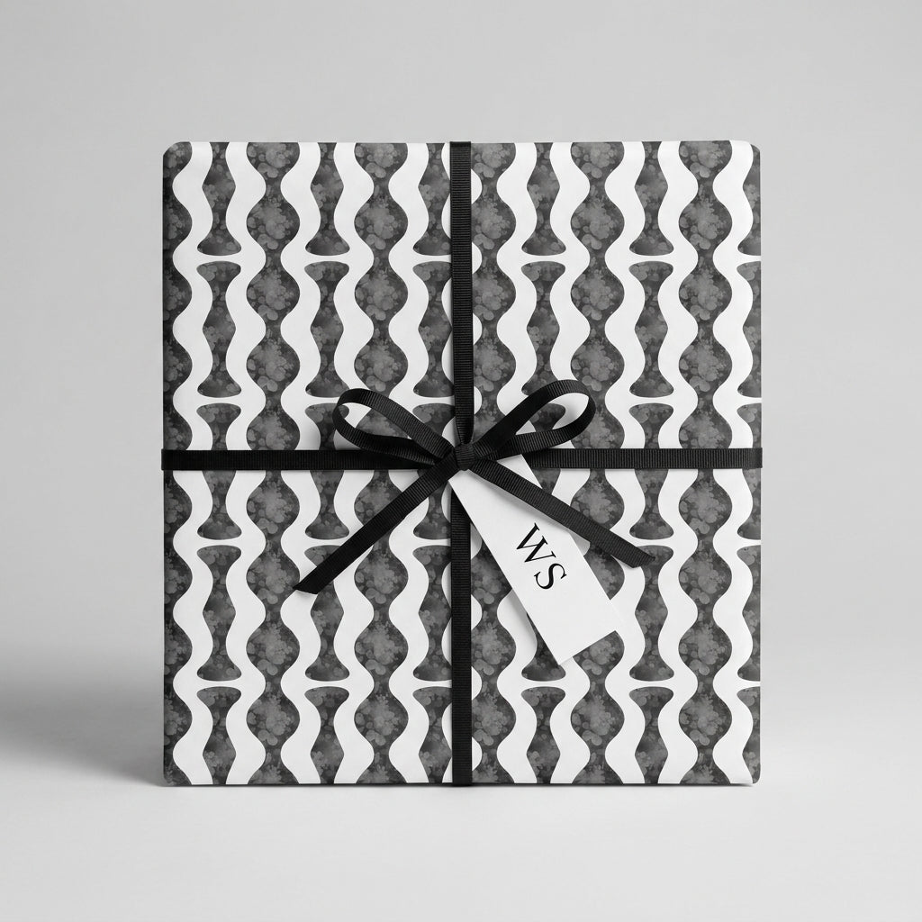 Modern black and white wavy geometric wrapping paper on a gift box by Wrapped Studios.