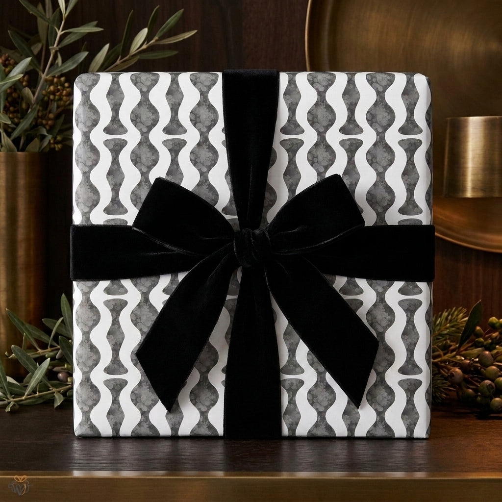 Modern black and white geometric wrapping paper with a luxury black velvet bow by Wrapped Studios.