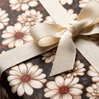Vintage daisy floral wrapping paper with cream ribbon bow, luxury gift wrap by Wrapped Studios.