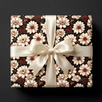 Vintage floral wrapping paper with cream daisies and a satin bow on a gift box by Wrapped Studios.