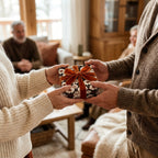 Hands exchanging a gift in vintage floral wrapping paper with a velvet bow by Wrapped Studios.