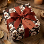 Vintage floral wrapping paper with daisies and a rust ribbon on a rustic gift box by Wrapped Studios.
