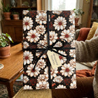 Moody vintage floral wrapping paper with cream daisies and a black bow by Wrapped Studios.