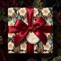 Vintage floral wrapping paper with a luxury red satin bow and gift tag by Wrapped Studios.
