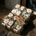 Vintage floral Christmas wrapping paper with twine bow and Noel tag by Wrapped Studios.