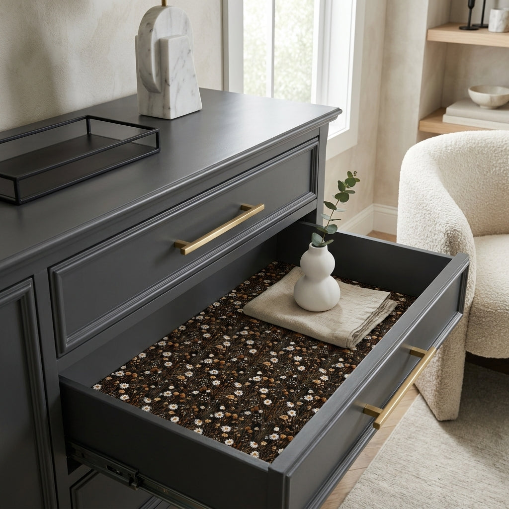 Dark floral wrapping paper by Wrapped Studios lining a modern grey dresser drawer.