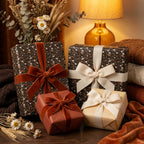 Vintage floral wrapping paper and luxury velvet ribbons on cozy gift boxes by Wrapped Studios.