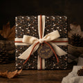 Rustic vintage floral wrapping paper with a cream velvet bow on a gift box by Wrapped Studios.