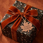 Luxury vintage floral wrapping paper with a rust velvet bow on a cozy autumn gift by Wrapped Studios.