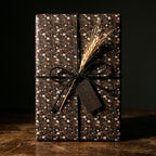 Rustic dark floral wrapping paper with white daisies and black twine by Wrapped Studios.