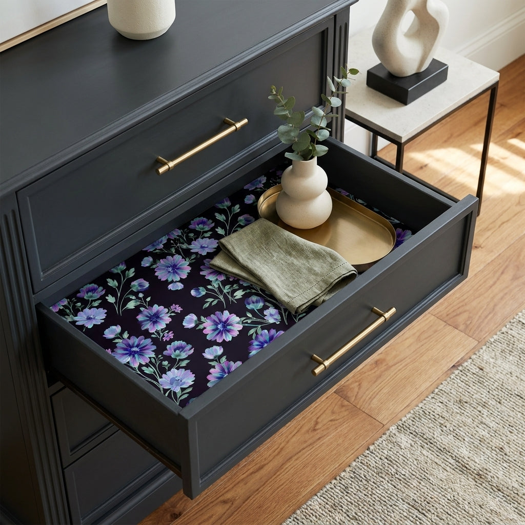 Moody purple floral wrapping paper used as drawer liner in a black dresser by Wrapped Studios.