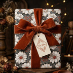 Vintage floral wrapping paper with a rust velvet bow and gift tag by Wrapped Studios.