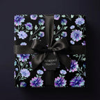Luxury dark floral wrapping paper with purple flowers and a satin bow, by Wrapped Studios.