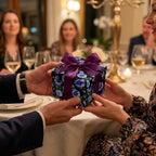 Luxury floral wrapping paper on a gift box with a purple bow at an elegant dinner by Wrapped Studios.