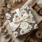 Elegant vintage floral wrapping paper with a cream satin bow on rustic wood background by Wrapped Studios.
