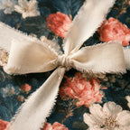 Vintage floral wrapping paper with pink peonies and a frayed ivory ribbon bow, by Wrapped Studios.