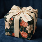 Vintage floral wrapping paper with cream velvet ribbon on a luxury gift box by Wrapped Studios.