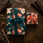 Vintage floral wrapping paper with elegant teal and coral satin bows on a wood table, by Wrapped Studios.