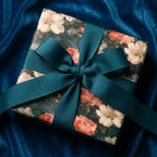 Luxury vintage floral wrapping paper with a teal ribbon bow on blue velvet by Wrapped Studios.