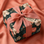 Luxury vintage floral wrapping paper with a coral pink ribbon bow, by Wrapped Studios.