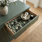 Luxury green forest wrapping paper used as a drawer liner in a modern sage cabinet by Wrapped Studios.