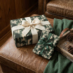 Rustic forest Christmas gift wrap by Wrapped Studios on holiday presents with a cream burlap bow.