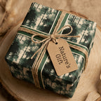 Rustic green forest wrapping paper with a twine bow and gift tag on a wood slice by Wrapped Studios.
