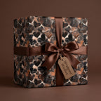 Wrapped Studios luxury gift wrap with brown heart pattern and satin ribbon.