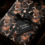 Wrapped Studios luxury gift wrap with brown heart pattern and black ribbon.
