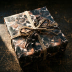 Heart print wrapping paper, twine bow on square gift box.