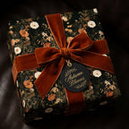 Luxury autumn floral wrapping paper by Wrapped Studios on a gift box with a rust velvet bow.