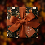 Vintage floral wrapping paper with a burnt orange ribbon and gift tag by Wrapped Studios.