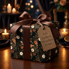 Moody floral wrapping paper with brown satin bow. Dark botanical luxury gift wrap by Wrapped Studios.