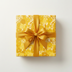 Square gift wrapped in yellow floral wrapping paper with a gold satin bow.