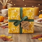 Autumn gift with floral wrapping paper, dark green ribbon, and "Autumn Bloom" tag.