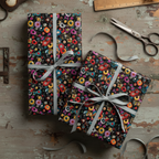 Two gifts wrapped in retro record print paper with silver ribbon on a rustic wood table.