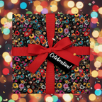 Square gift wrapped in vinyl record patterned wrapping paper with red ribbon & "Celebration!" tag.