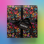 Retro record album wrapping paper with black ribbon, "Surprise!" tag; fun birthday gift wrap.
