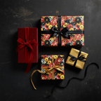 Elegant presents wrapped in luxury gift wrap with modern circle patterns and velvet ribbon on a dark background.