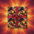 Square gift wrapped in record-themed birthday wrapping paper with a red ribbon.