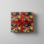 Square gift wrapped in modern circle patterned wrapping paper with a bright red satin bow.