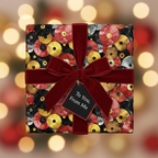 Square gift box wrapped in vinyl record wrapping paper with red velvet ribbon.
