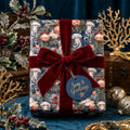 Coastal Christmas wrapping paper with jellyfish pattern and burgundy velvet bow by Wrapped Studios.