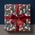 Coastal Christmas wrapping paper with jellyfish and ornaments, tied with a red bow by Wrapped Studios.