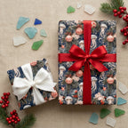 Coastal Christmas wrapping paper with jellyfish by Wrapped Studios, featuring red and white satin bows.